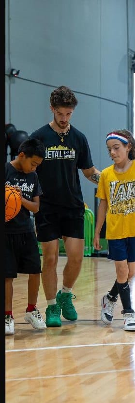 Youth players running a drill at a DETAIL San Diego session